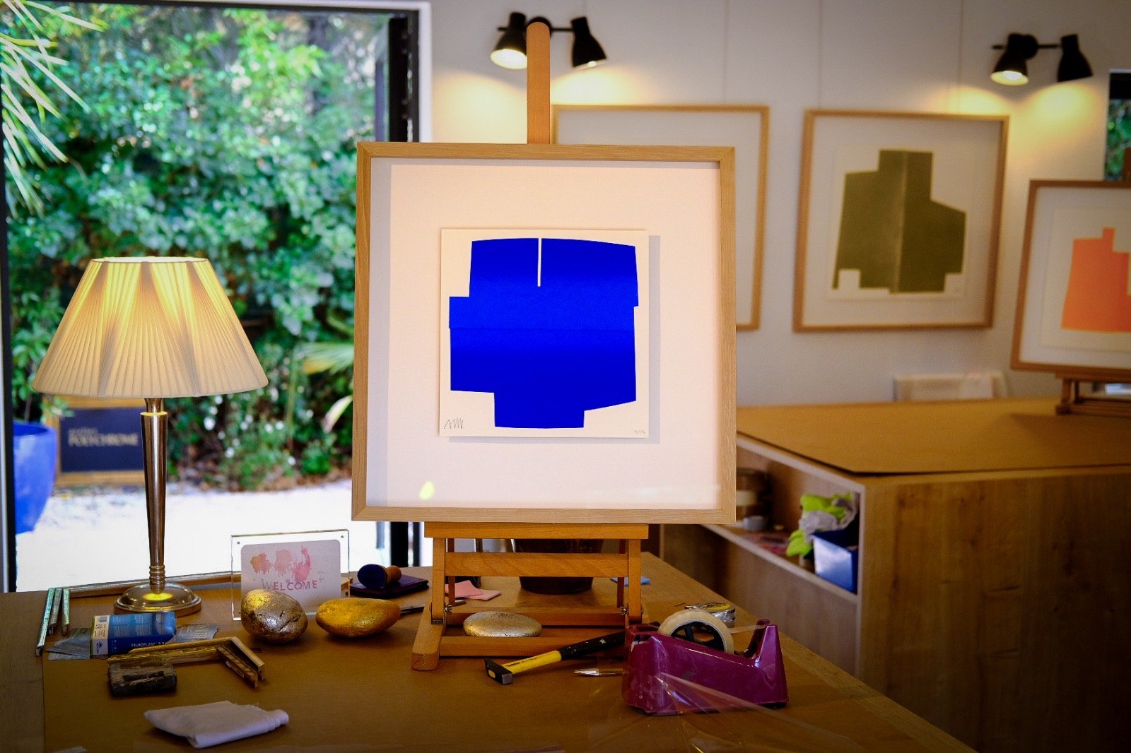 Œuvre bleue sur un chevalet dans la galerie de l’Atelier Polychrome